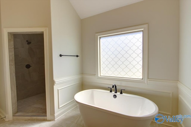 13888 Mallard Dr, Madison, AL 35756 - bathroom with a tile shower, a freestanding bath, wainscoting, and tile patterned flooring