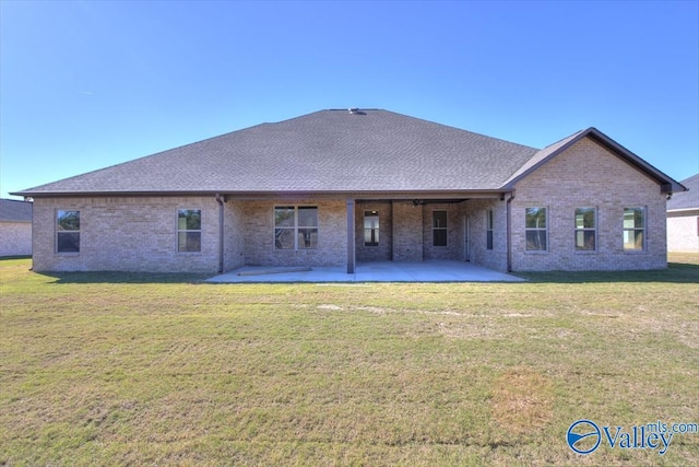 13888 Mallard Dr, Madison, AL 35756 - back of house featuring brick siding, a patio area, a lawn, and roof with shingles