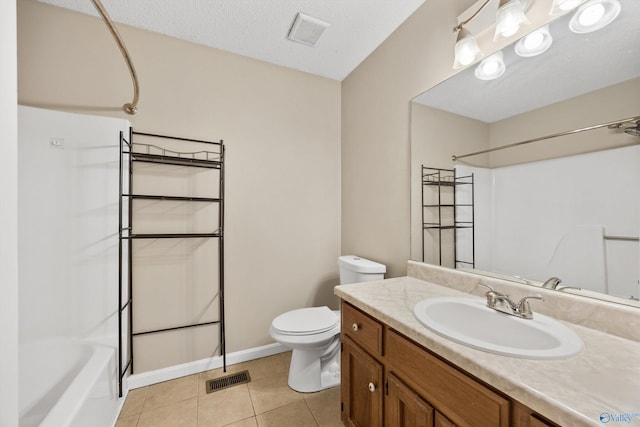 full bathroom featuring toilet, washtub / shower combination, tile patterned floors, a textured ceiling, and vanity