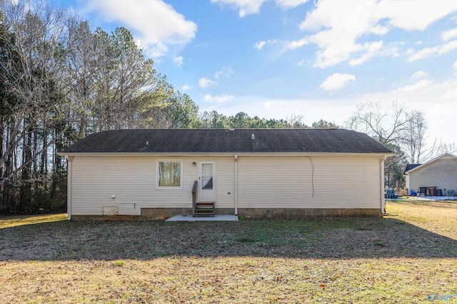 back of house with a lawn