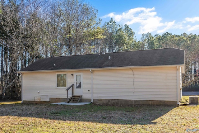 rear view of property featuring a lawn