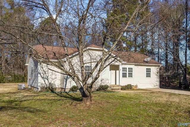 view of front of property featuring a front lawn and cooling unit