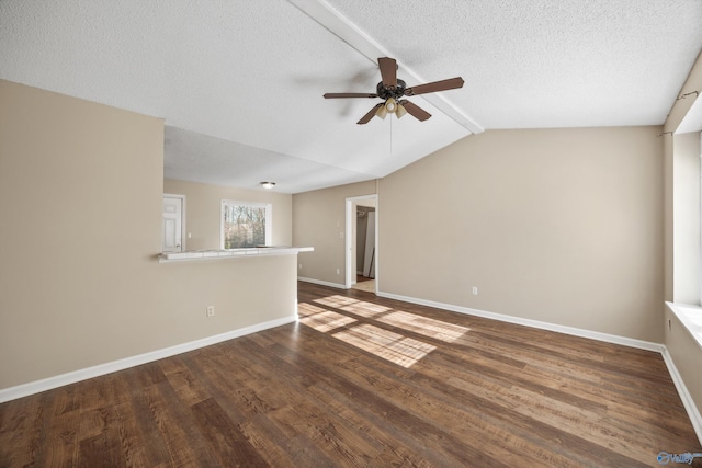 unfurnished room featuring ceiling fan, a textured ceiling, dark hardwood / wood-style flooring, and lofted ceiling