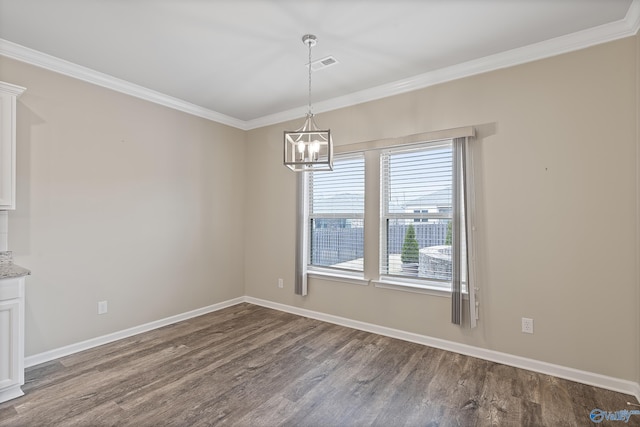 unfurnished dining area featuring hardwood / wood-style flooring, ornamental molding, and a notable chandelier