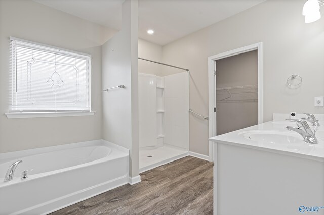 bathroom with vanity, independent shower and bath, and hardwood / wood-style flooring