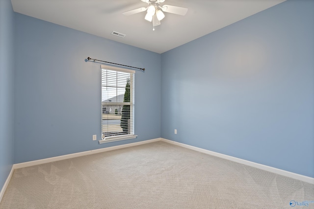 carpeted spare room featuring ceiling fan