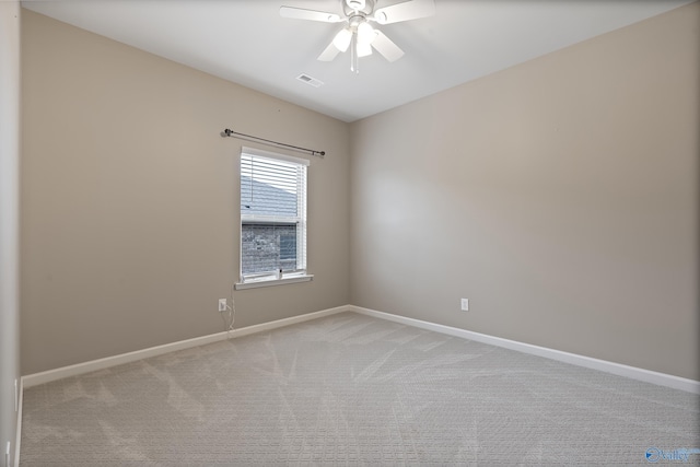 spare room with light colored carpet and ceiling fan