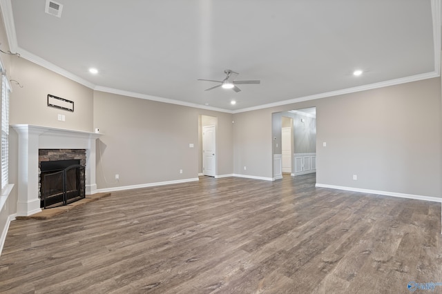 unfurnished living room with a stone fireplace, ceiling fan, wood-type flooring, and ornamental molding