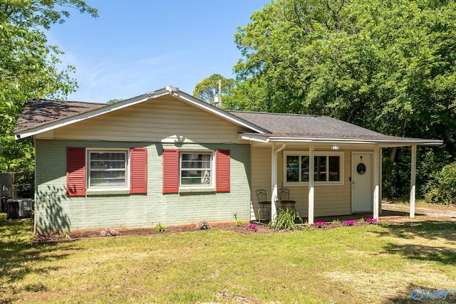 1101 5th Ave SW, Decatur, AL 35601 - bungalow-style home featuring a front yard, brick siding, a shingled roof, and central air condition unit