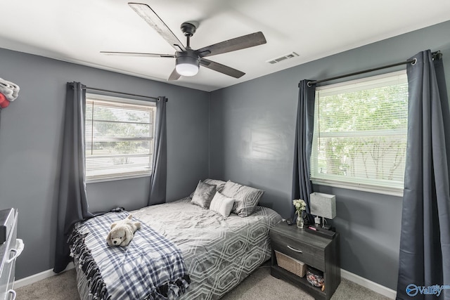 1101 5th Ave SW, Decatur, AL 35601 - carpeted bedroom featuring multiple windows, baseboards, and ceiling fan