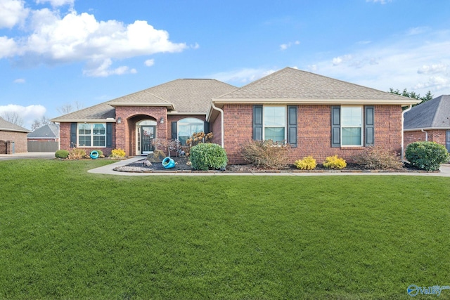 single story home featuring a front lawn