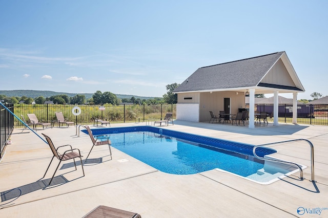 view of swimming pool featuring a patio, fence, and a fenced in pool