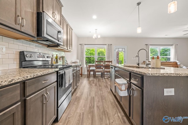 140 Amelia Dr, Harvest, AL 35749 - kitchen with appliances with stainless steel finishes, light wood finished floors, a sink, and healthy amount of natural light