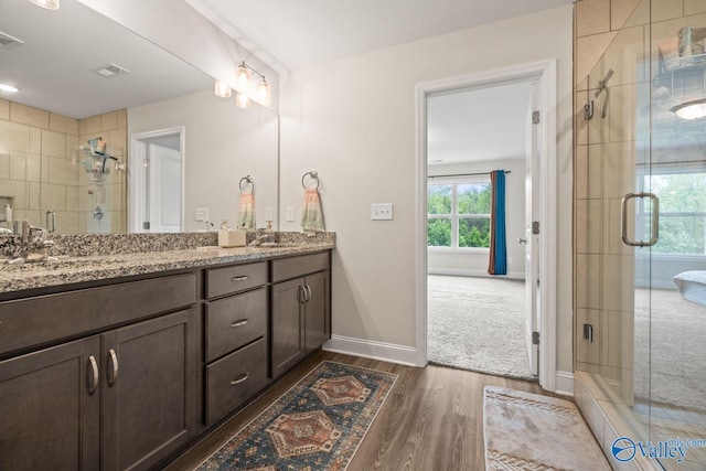 140 Amelia Dr, Harvest, AL 35749 - full bath with wood finished floors, a shower stall, double vanity, and baseboards