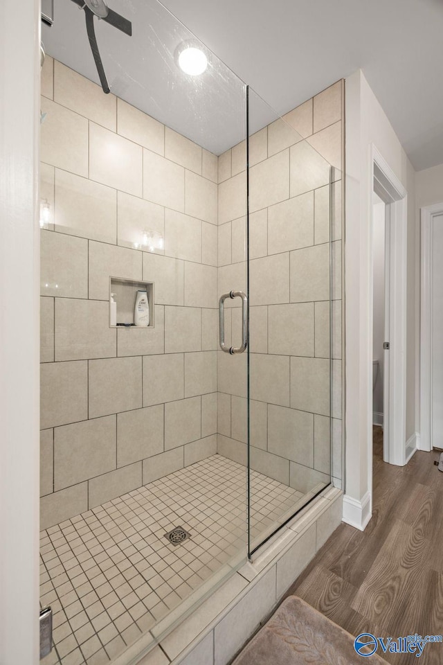 140 Amelia Dr, Harvest, AL 35749 - full bathroom with wood finished floors, a shower stall, and baseboards