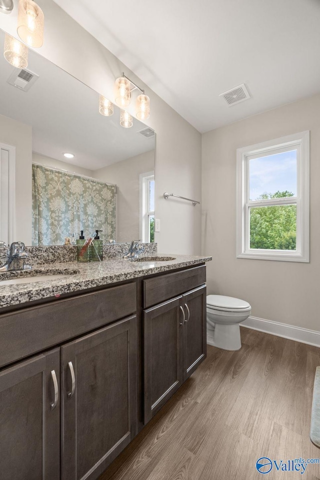 140 Amelia Dr, Harvest, AL 35749 - full bathroom featuring wood finished floors, toilet, vanity, and baseboards