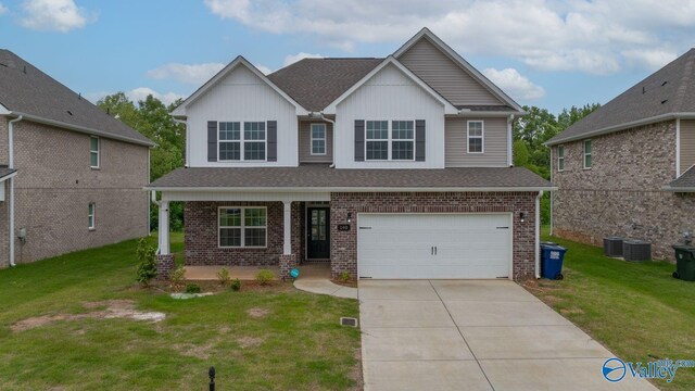 140 Amelia Dr, Harvest, AL 35749 - view of front facade with brick siding, a garage, a front lawn, and driveway