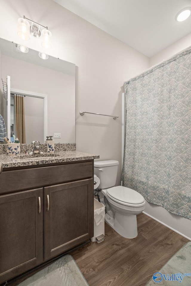 140 Amelia Dr, Harvest, AL 35749 - full bath featuring wood finished floors, toilet, vanity, and a shower with shower curtain