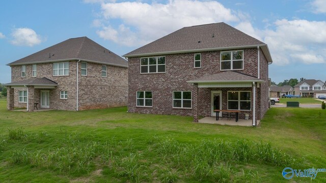 140 Amelia Dr, Harvest, AL 35749 - rear view of house featuring a patio, a lawn, and brick siding