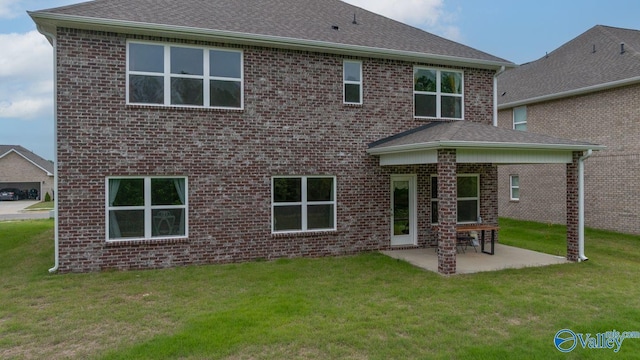 140 Amelia Dr, Harvest, AL 35749 - rear view of house with a patio area, a yard, brick siding, and roof with shingles