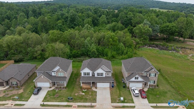 140 Amelia Dr, Harvest, AL 35749 - aerial perspective of suburban area featuring a heavily wooded area