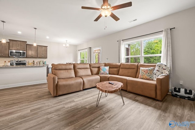 140 Amelia Dr, Harvest, AL 35749 - living room featuring light wood finished floors, recessed lighting, ceiling fan, and a chandelier