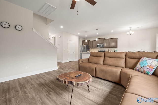 140 Amelia Dr, Harvest, AL 35749 - living room featuring wood finished floors, a ceiling fan, recessed lighting, baseboards, and a chandelier