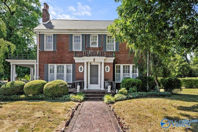 colonial home with a front lawn