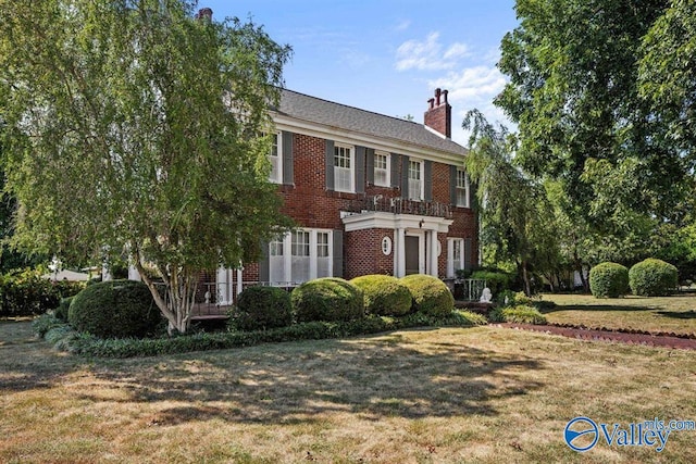 colonial-style house with a front yard