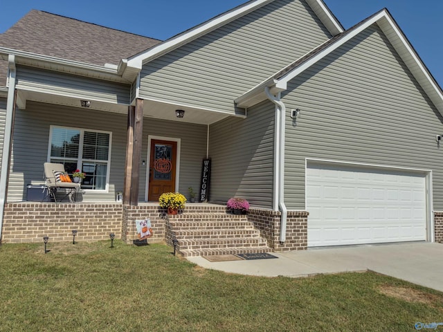 view of front of home with a garage and a front lawn