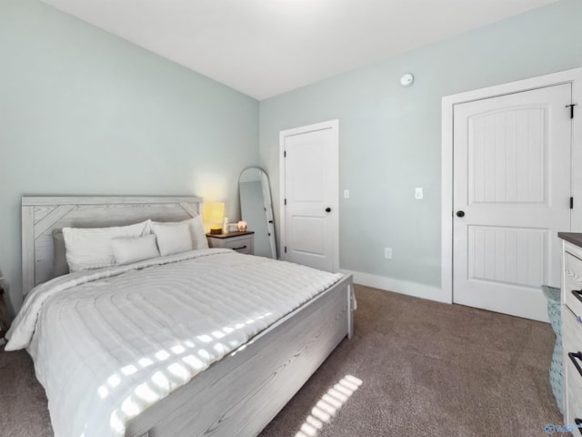 bedroom featuring dark carpet