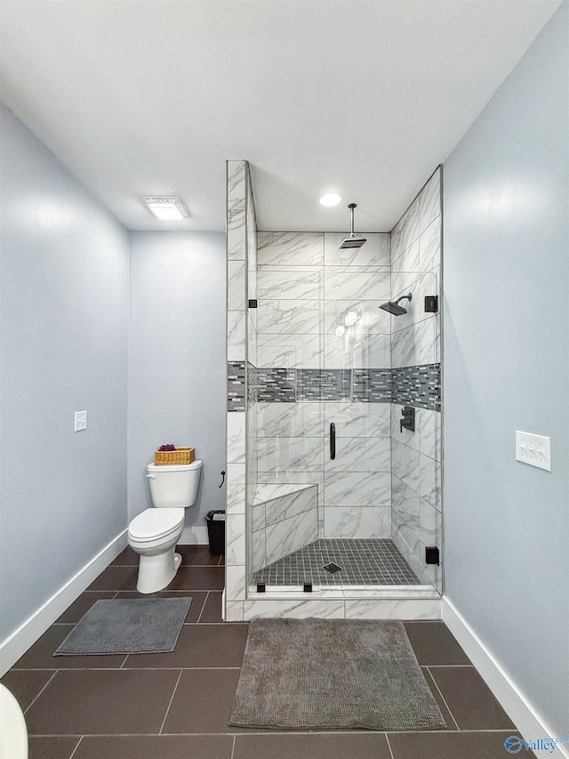 bathroom featuring walk in shower, tile patterned flooring, and toilet