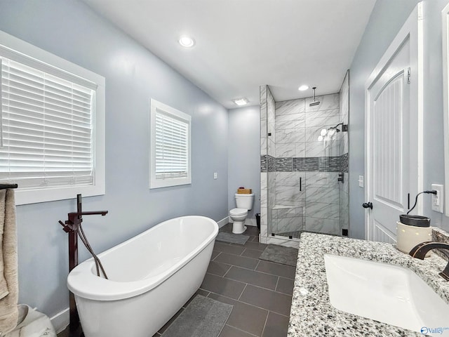 full bathroom with vanity, separate shower and tub, toilet, and tile patterned floors