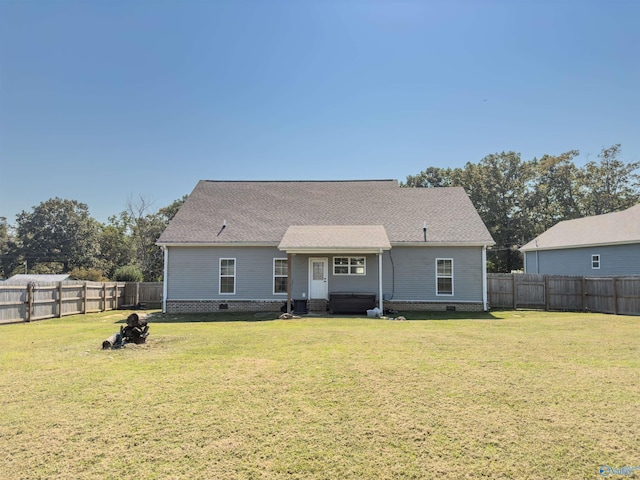 rear view of property with a yard