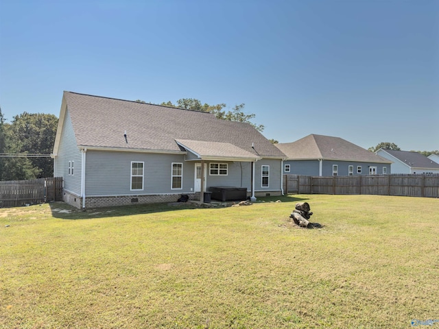 rear view of house with a yard