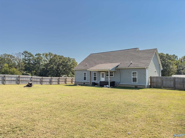 rear view of property with a lawn