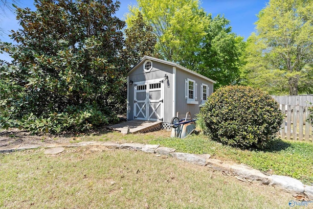 view of shed featuring fence