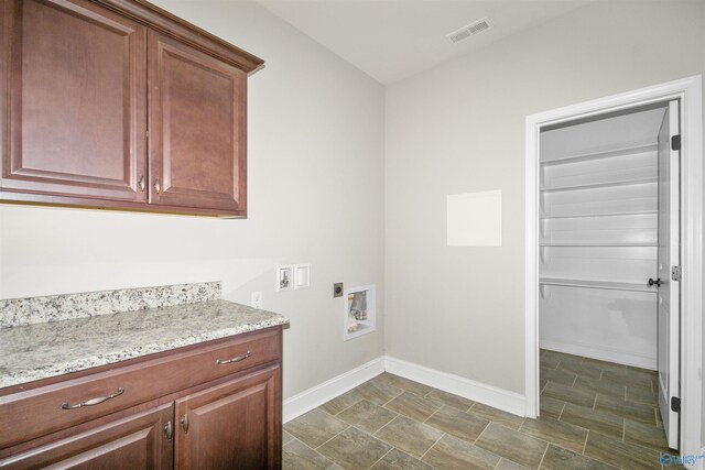 clothes washing area featuring hookup for an electric dryer, washer hookup, and cabinets