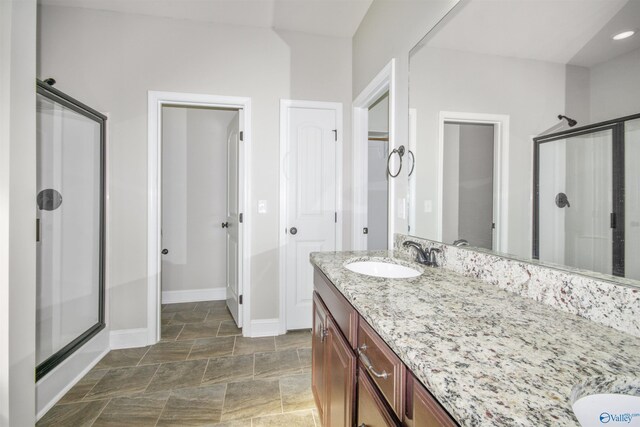 bathroom featuring vanity and an enclosed shower