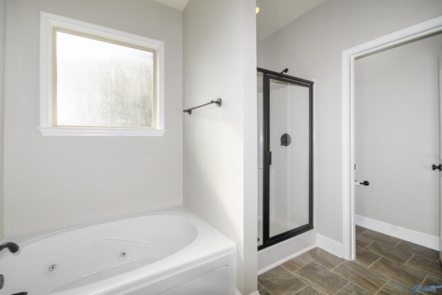 bathroom featuring shower with separate bathtub