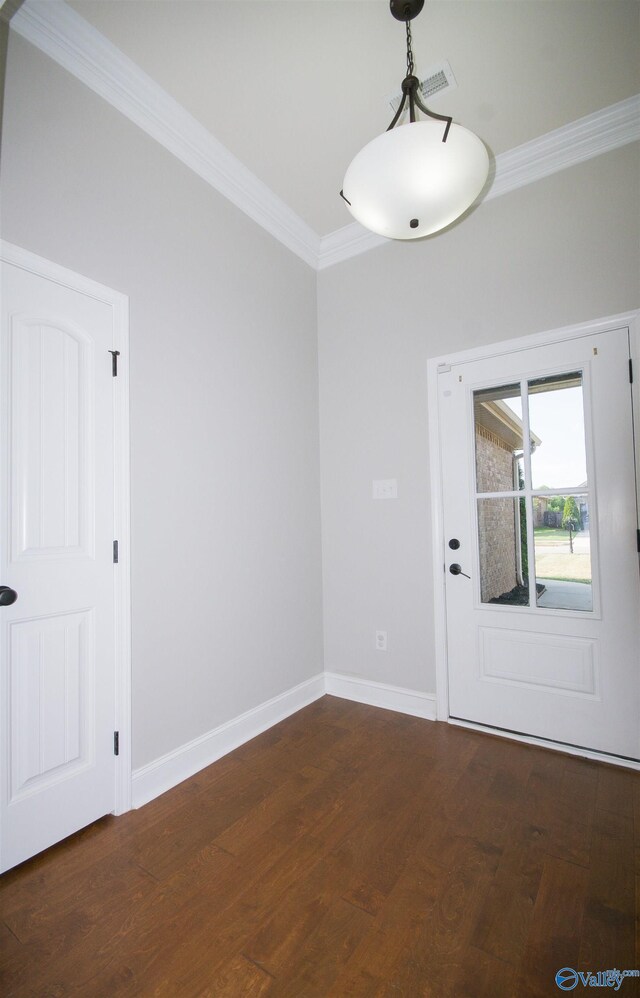 empty room featuring ornamental molding and dark hardwood / wood-style flooring