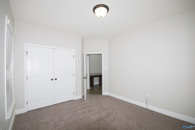 unfurnished bedroom featuring a closet and carpet