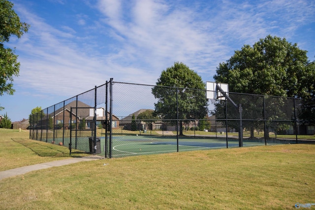 view of sport court with a yard