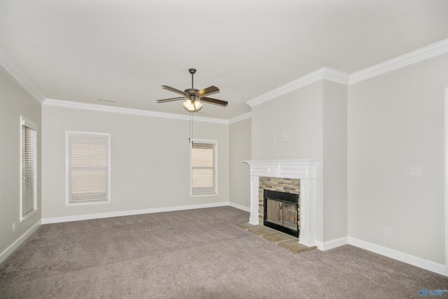 unfurnished living room with ornamental molding, light colored carpet, a fireplace, and ceiling fan