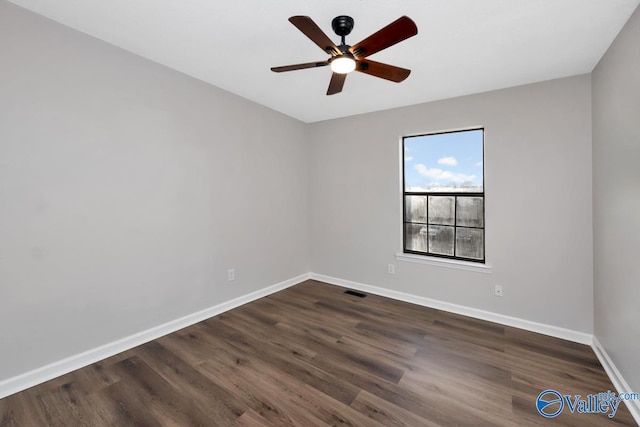 spare room with ceiling fan and dark hardwood / wood-style floors