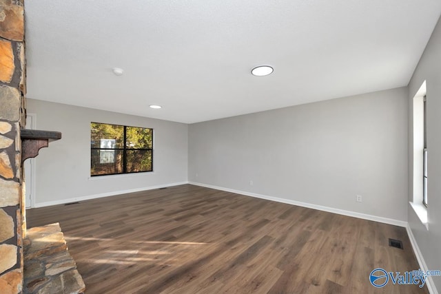 unfurnished living room featuring dark wood-type flooring