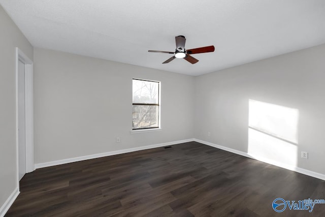 unfurnished room with ceiling fan and dark hardwood / wood-style flooring