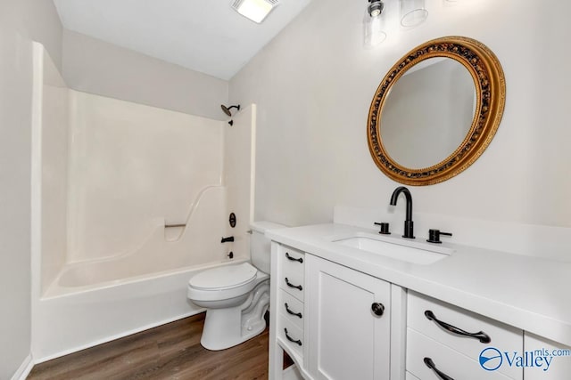 full bathroom with wood-type flooring, toilet, shower / bath combination, and vanity