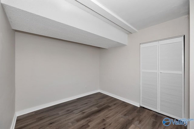 interior space featuring a closet and dark hardwood / wood-style floors