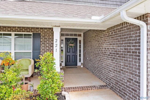 221 Alonzo Toney Dr, Madison, AL 35756 - doorway to property featuring brick siding and covered porch